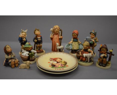 A collection of Hummel figures and plates.