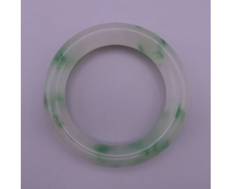 A jade bangle. 7.5 cm exterior diameter, 5.5 cm interior diameter.