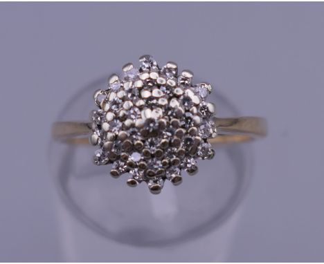 A 9 ct gold diamond cluster ring. Ring size K/L. 2.7 grammes total weight.