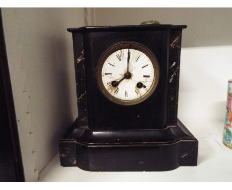 A Victorian faux slate mantel clock, the enamelled dial with Roman numerals, raised on a stepped base