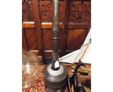 A Moroccan carved hardwood and white metal coffee bean grinder, pestle and mortar