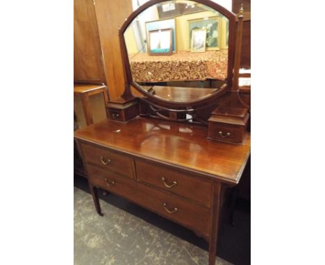 An Edwardian boxwood and chequer strung mahogany dressing chest, the central bevelled mirror above a fretwork gallery flanked