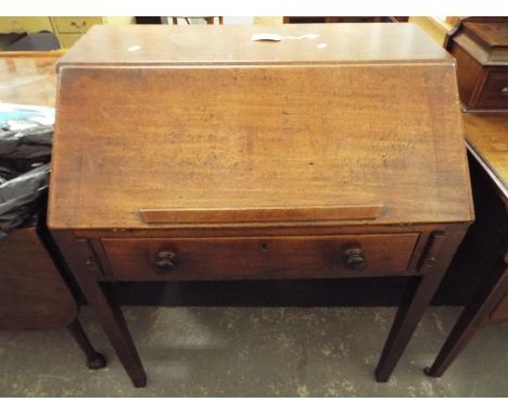 A mahogany estates desk with full flap single frieze drawer resting on tapering supports