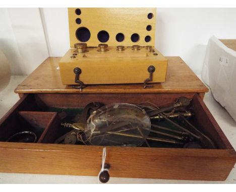 A boxed set of brass scales and weights