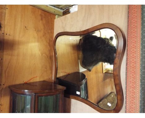 A shaped mahogany framed bevelled glass mirror