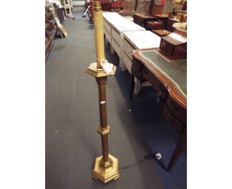 A gilt and wooden floor lamp