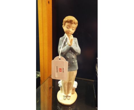 A Nao figurine of a 'Praying Boy', marks to base   In good condition 