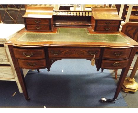 A mid-19thC rosewood and satin wood inlaid desk the top gallery inlaid with vases, swags, dragons, lyres and scrolls, having 