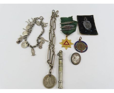 A rope bracelet with various charms attached, charms include an owl, a violin and others; part of a silver Albert chain with 