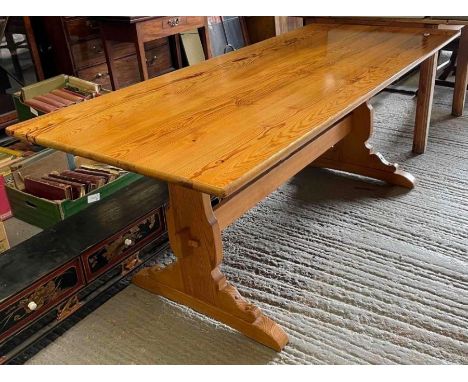 A rectangular pine trestle style table 183cm x 80.5cm together with a set of four Ercol light wood stick back chairs