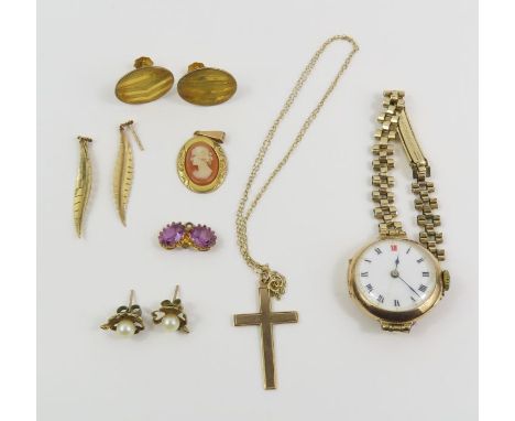 A 9ct gold cameo pendant, a cross marked '9ct', a trace chain marked '375', a pair of unmarked leaf shaped earrings (tests as