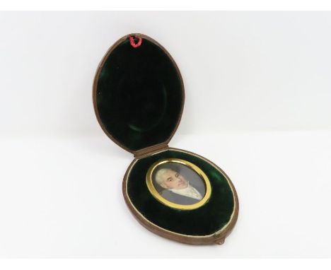 An early 19th century miniature portrait on ivory of a gentleman enclosed in oval leather covered case the inner cover with c