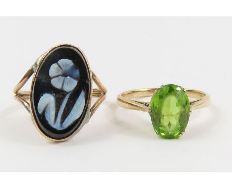 A single green stone ring, marked '9ct', finger size N; together with a black and white hardstone ring, unable to size as ban