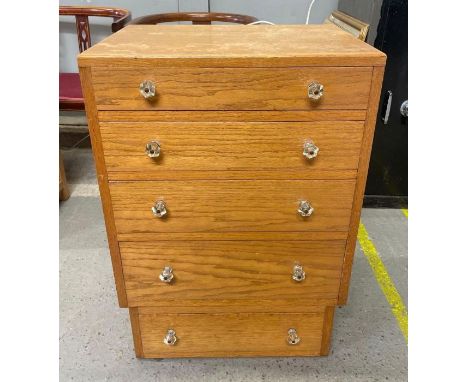 A light oak chest of five long drawers with faceted clear celluloid handles, 79.5cm high 56cm wide 41cm deep