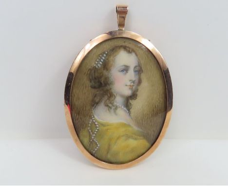A 19th century oval miniature portrait on ivory of a young woman in a yellow dress with beads in her hair, mounted in oval un