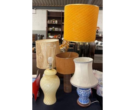 A tall green glazed pottery table lamp with large orange shade together with four other large table lamps