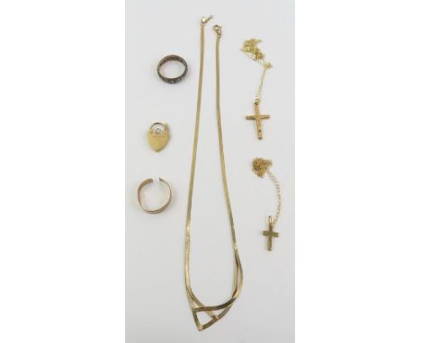 A 9ct gold band ring, cut off; a 9ct gold heart padlock; a 9ct gold flat link necklace; two trace chains, marked '375'; a cro