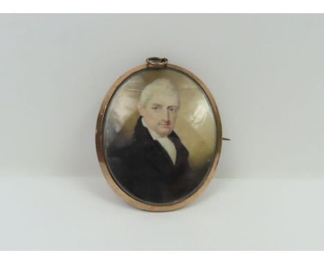 A late 18th/early 19th century oval miniature portrait on ivory of a gentleman the reverse with decorative momento mori initi
