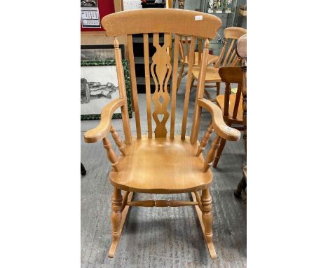 A 20th century light wood farmhouse style rocking chair