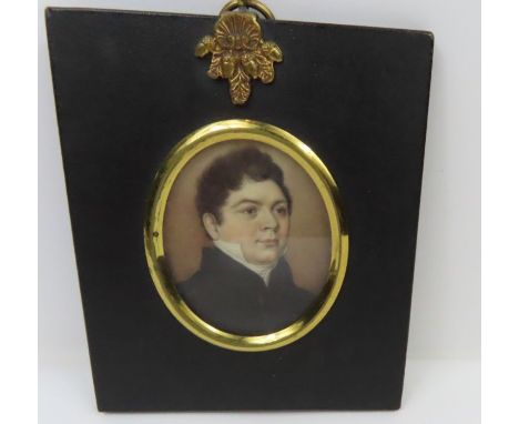 An early 19th century oval miniature portrait of a gentleman, on ivory panel, the well detailed portrait in black frame with 