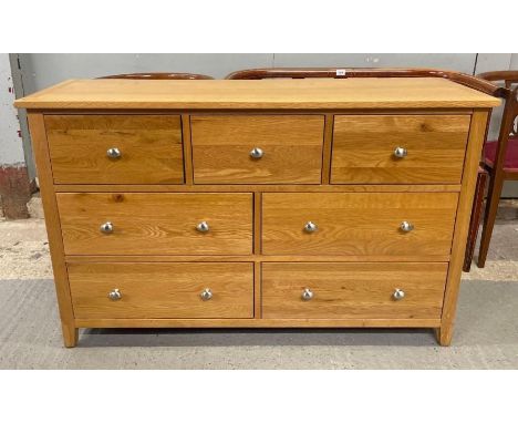 A light oak chest of short drawers, 78cm high 125cm wide 40cm deep
