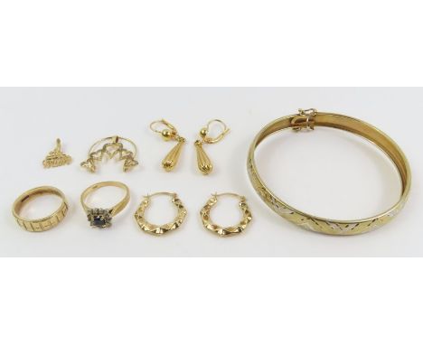 A patterned band ring, marked '10k', finger size N, and a pair of facetted hoop earrings, marked '10k', and a charm hanging p