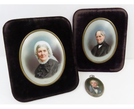 An oval miniature portrait on porcelain of an early 19th century gentleman wearing a blue coat and black stock, in metal fram
