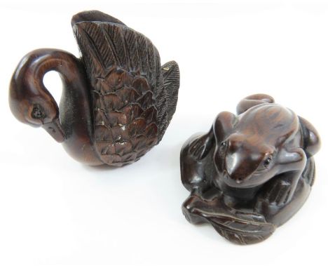 Two 20th century carved hardwood Japanese netsuke, one of a crawling toad the other a swan