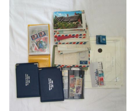 A box containing a collection of mixed stamps, commemorative bank notes, post cards, etc