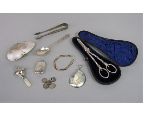 A good collection of bijouterie silver to include Irish silver sugar tongs, vesta case, pearl handled baby rattle, part fitte