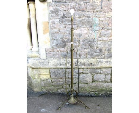 An Art Nouveau brass telescopic oil lamp standard, the central stem flanked by whiplash supports, circular weighted base and 