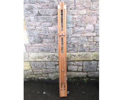 A folding and adjustable beechwood floorstanding artists easel