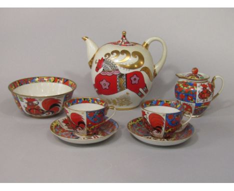 A collection of brightly coloured Russian ceramics comprising a teapot of globular form with red and gilt galloping horse and
