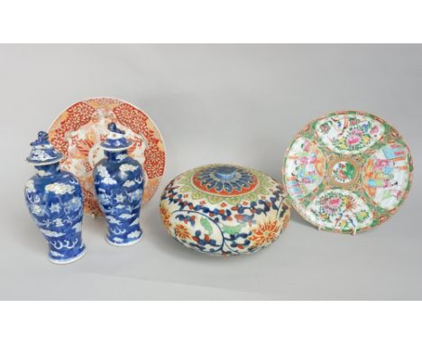 An oriental pot and cover of circular form with polychrome painted stylised floral decoration, 24cm diameter approx, together