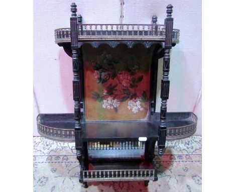 An aesthetic movement wall shelf, with carved and moulded frame and ebonised finish, set of three tiers, with brass balustrad