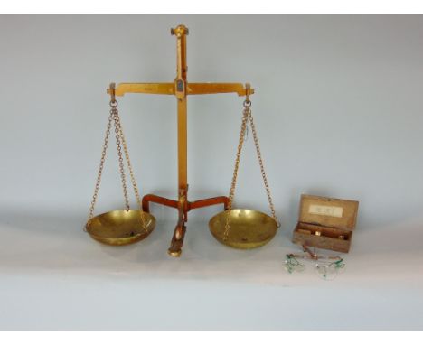 Pair of brass balance scales with a small quantity of weights