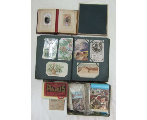 An album containing a quantity of early 20th century onwards British and worldwide topographical postcards including a number