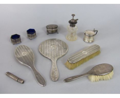A mixed collection of silver to include four dressing set items comprising three brushes and a hand mirror, a silver mustard 