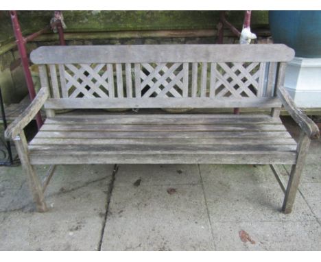 A weathered contemporary teak three seat garden bench with lattice work panelled back and slatted seat, 5ft long 