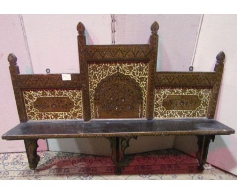 A 19th century Indian wall shelf, with original painted detail, showing arches and repeating floral and geometric detail, wit