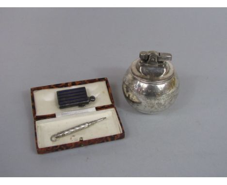 Silver 'witch ball' lighter, together with a further silver engine turned and enamel note pad and pencil and further silver p