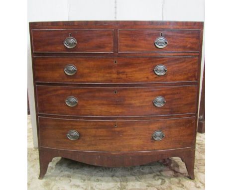 A Georgian mahogany bow-fronted chest of three long and two short graduated drawers, raised on swept supports, with caddy top