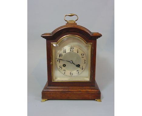 A good quality oak cased two train bracket type mantel clock, the arched silver dial with silver chapter ring with arabic num