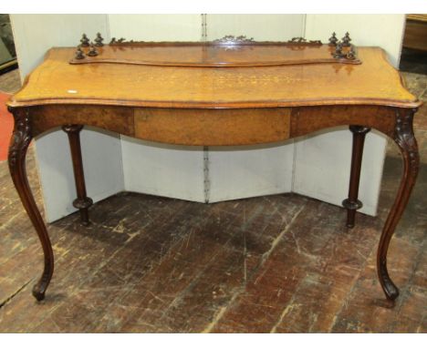 A mid-Victorian period walnut and burr walnut side table, raised on carved cabriole forelegs and turned rear supports, the to