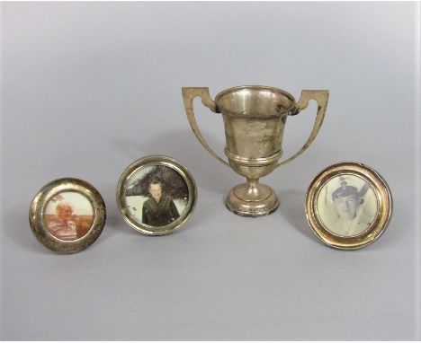 A mixed collection of silver to include a twin handled trophy, 4oz approx, together with three silver circular easel frames (