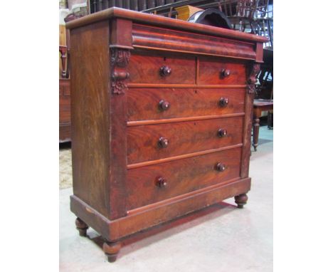 A substantial Victorian mahogany bedroom chest fitted with an arrangement of four long and two short drawers, with flame vene