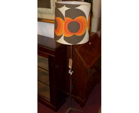 A 1960's chrome floor standing lamp, with orange, black and white shade, raised on tri-form base, H:153cm