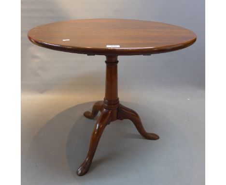 A 19th Century mahogany tilt top table raised on tripod legs