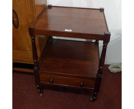 A 19th Century mahogany two tier lamp table with single drawer raised on turned legs and castors