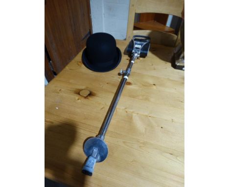     A Vintage Bowler Hat, Together With A Shooting Stick                            